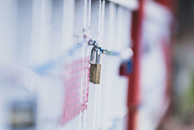 Close-up of padlocks hanging on railing