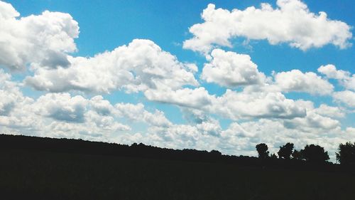 Silhouette trees on field against sky