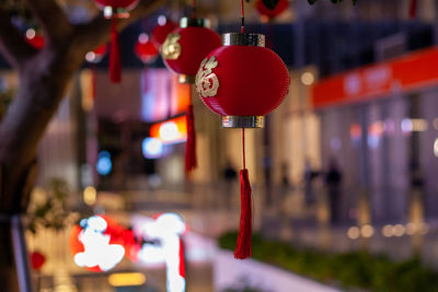 Close-up of illuminated lanterns hanging in temple