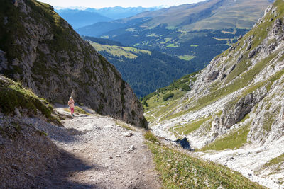 High angle view of girl walking on mountain trail