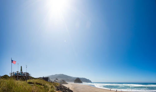 Scenic view of sea against blue sky on sunny day