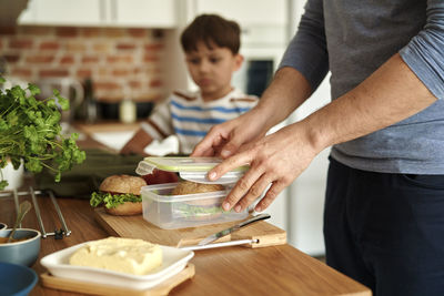 Midsection of man preparing food on table