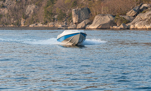 Boat on rock by sea