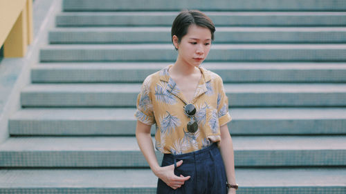 Woman standing against steps