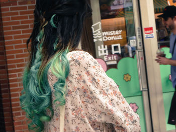 Rear view of woman standing on street