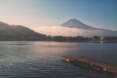 Scenic view of lake by mountains against sky