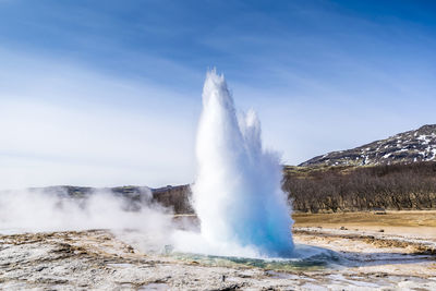 Scenic view of waterfall against sky