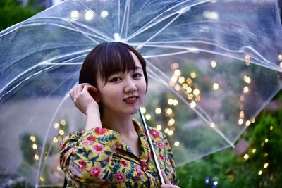 Portrait of a smiling young woman with umbrella 