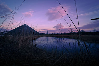 Scenic view of lake against sky at sunset