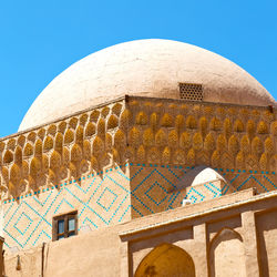 Low angle view of building against clear blue sky