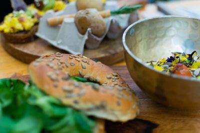 Close-up of bagel by bowl on table