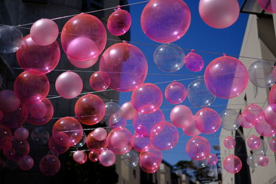 Low angle view of multi colored balloons