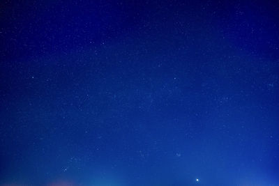 Low angle view of stars against blue sky