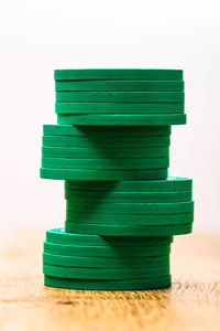 Close-up of stack on table against white background