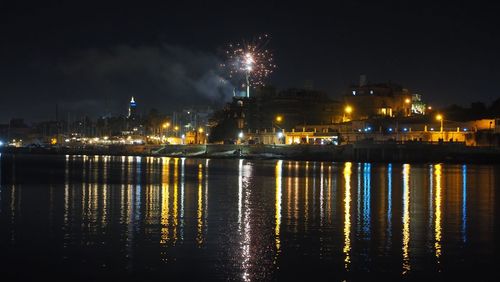 Fireworks display, illuminated city and light reflectio non water -  nye manoel island malta