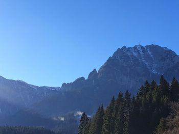 Scenic view of mountains against clear blue sky