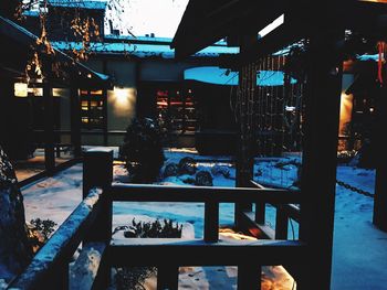 Illuminated electric lamp against sky at night