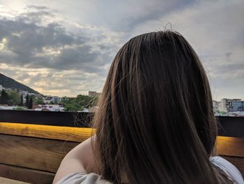 Rear view of woman against sky