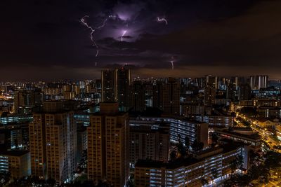 Aerial view of city lit up at night