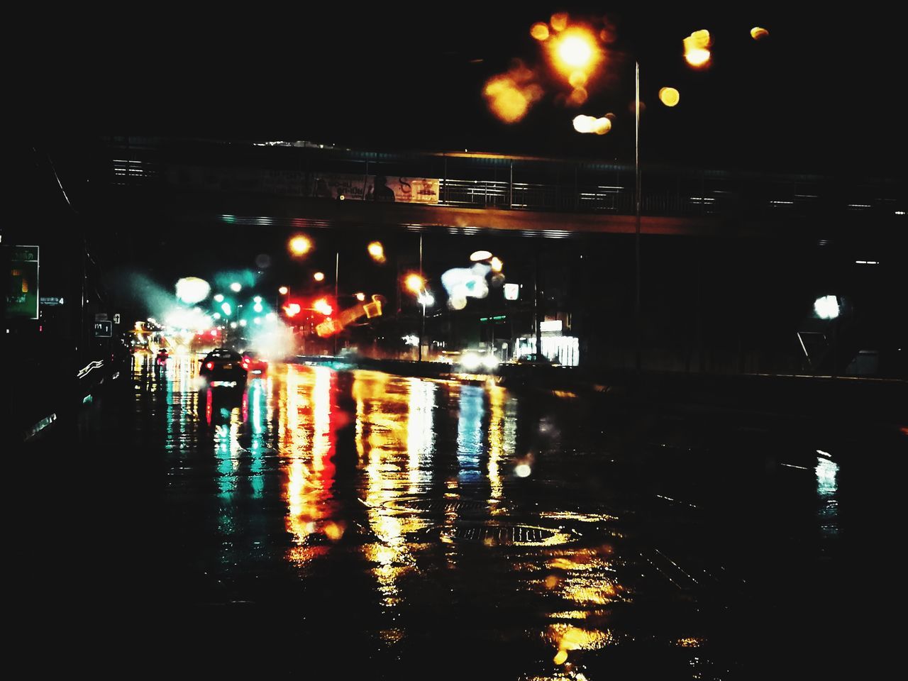 night, illuminated, street, city, architecture, transportation, water, reflection, building exterior, car, motor vehicle, street light, lighting equipment, wet, mode of transportation, road, built structure, rain, no people, city street, outdoors, dark, rainy season, light, nightlife