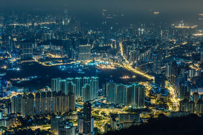 High angle view of illuminated buildings in city at night