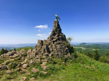 Rock formations on landscape against sky