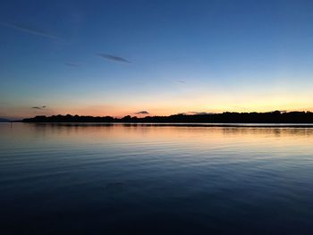 Scenic view of calm lake at sunset