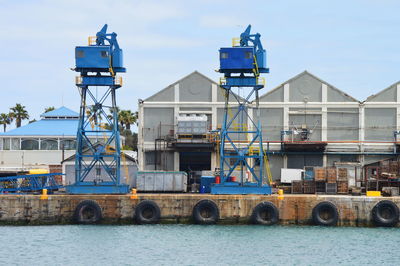 Commercial dock by sea against sky