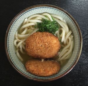 Close-up of udon noodles served on table