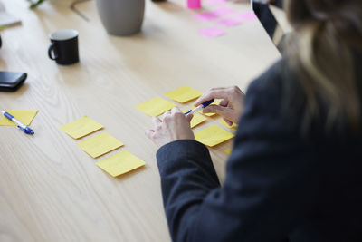 Woman's hands holding pen during meeting