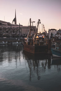 Sailboats in harbor at sunset