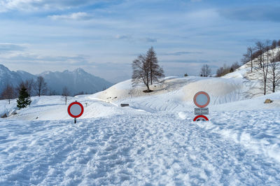 Road signs almost submerged in snow on campogrosso pass in italy.