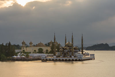 View of boats in sea against cloudy sky