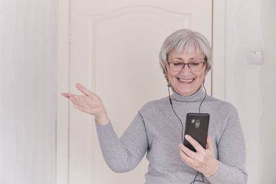 Smiling young woman using mobile phone