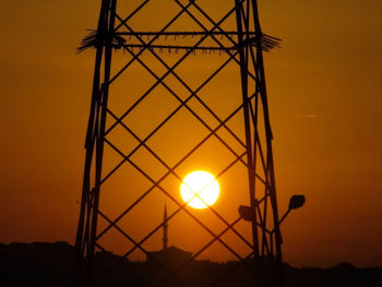 Low angle view of silhouette metal against sky during sunset