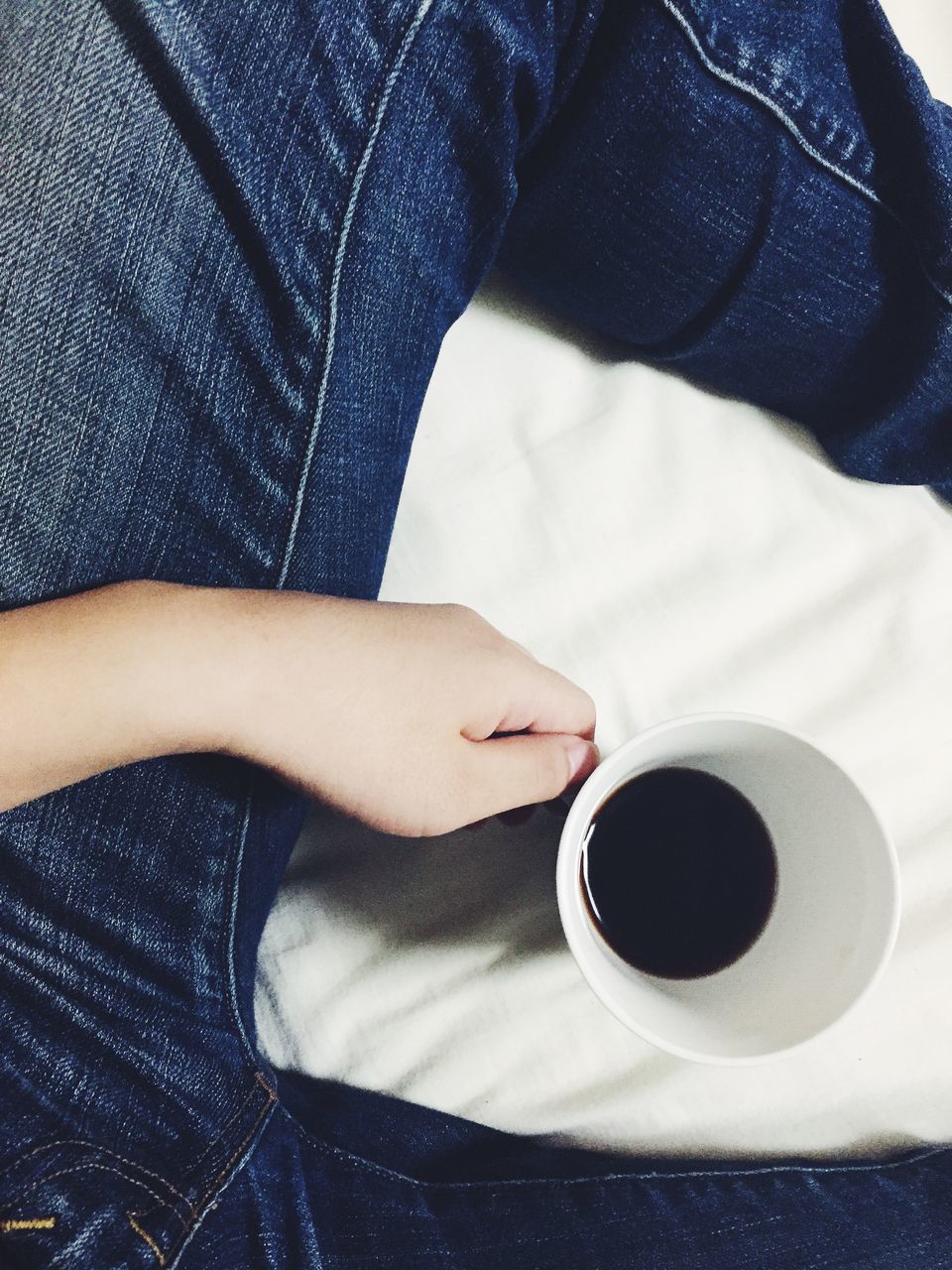 indoors, coffee cup, person, drink, holding, lifestyles, table, coffee - drink, part of, high angle view, food and drink, refreshment, close-up, personal perspective, coffee, cup