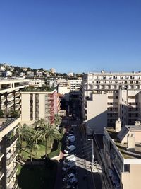 High angle view of buildings against clear blue sky