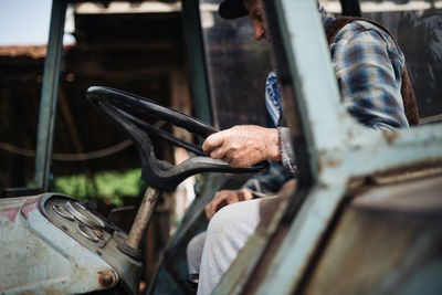 Old farmer driving a tractor.