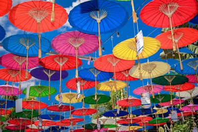 Low angle view of multi colored umbrellas hanging on clothesline