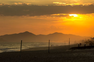 Scenic view of sea against orange sky