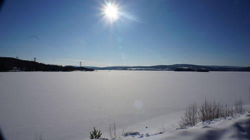 Scenic view of lake against clear sky during winter