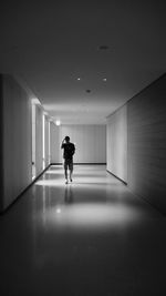 Woman standing in illuminated corridor