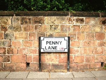 Close-up of text on brick wall