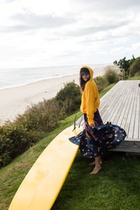 Stylish female surfer gets ready to surf