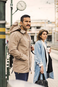 Man and woman waiting at tram station