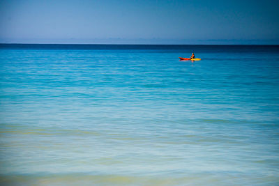 Man in canoe on sea