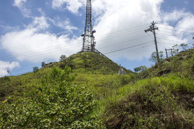 Low angle view of electricity pylon against sky