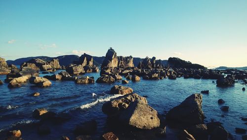 Panoramic view of rocks in sea against sky