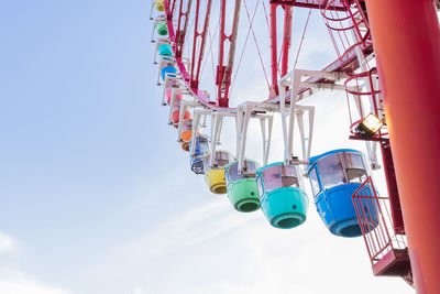 Low angle view of chain swing ride against sky