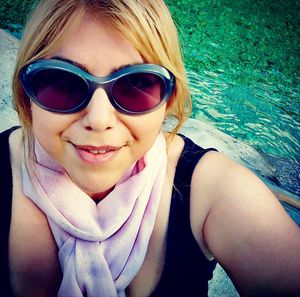 Portrait of a smiling young woman in swimming pool
